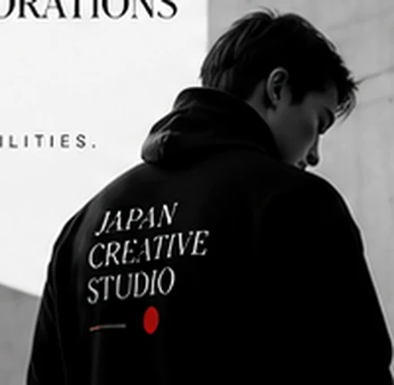 Monochrome photo of a designer wearing a black studio jacket